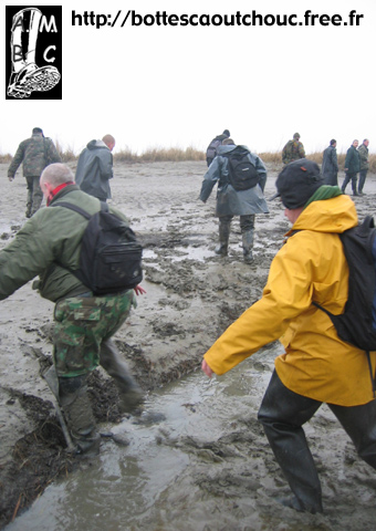 In waders in the mud.