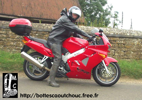 In waders & rubber on his motorbike.