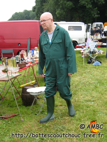 In a French flea-market, wearing green overalls, France, 2008. Gummistiefel, bottes caoutchouc.