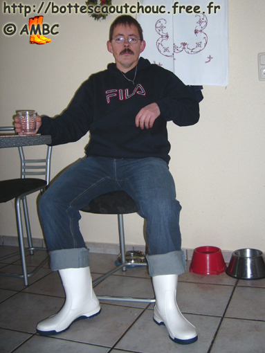 QUIET LARS IN WHITE WELLIES IN HIS KITCHEN.