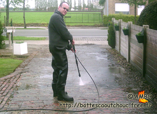 Cleaning the path, wearing black waders.  Gummistiefel, bottes caoutchouc, 2008.