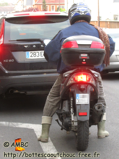 Young biker wearing wellies in the traffic, Melun, 26 April 2011. Gummistiefel, rubber boots, bottes caoutchouc.
