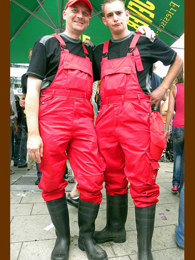 Wearing red bib & braces & pvc boots, Hamburg, August 2009.