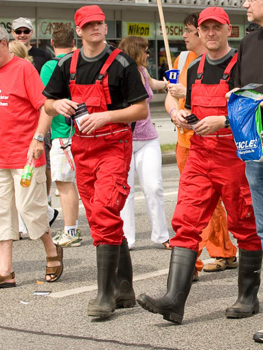 Wearing red bib & braces & pvc boots, Hamburg, August 2009.