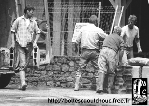 Workers in Brittany, France. Rubber boots.