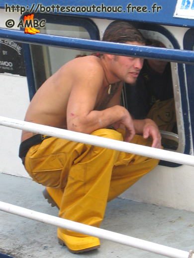 Young tatooed  fisherman wearing PVC in Cherbourg, 2004. 