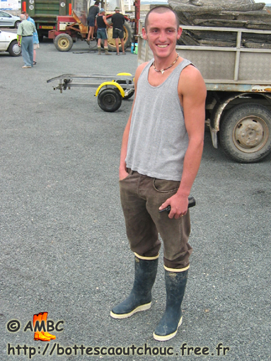 Young smiling fisherman wearing Le Chameau rubber boots, Bourcefranc, France, 2003.