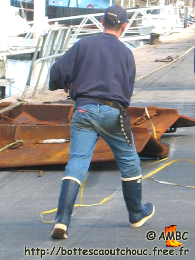 Young  fisherman wearing Le Chameau rubber boots, Cherbourg, France, 2004.