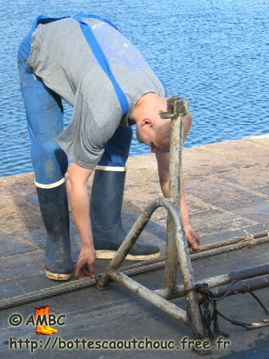 Young  fisherman wearing Le Chameau rubber boots, Cherbourg, France, 2004.