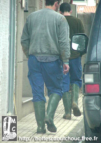 Young workers in green PVC boots