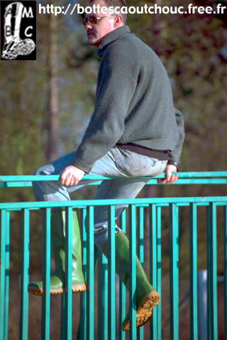Pascal on a bridge, wearing Superga wellies.