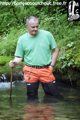 Wearing waders in a  mountain river.