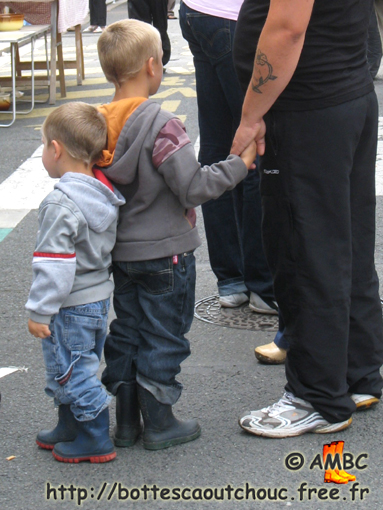 Kids in wellies and their tattoed father, 2009.