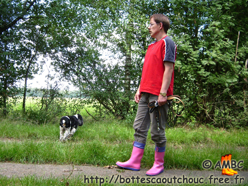 Lars walking his dog, wearing pink PVC wellies; rubber boots, 2008.