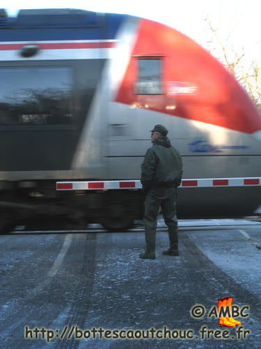In waders in front of the local train, 2007. Gummi Waders, cuissardes caoutchouc, rubber hip boots.