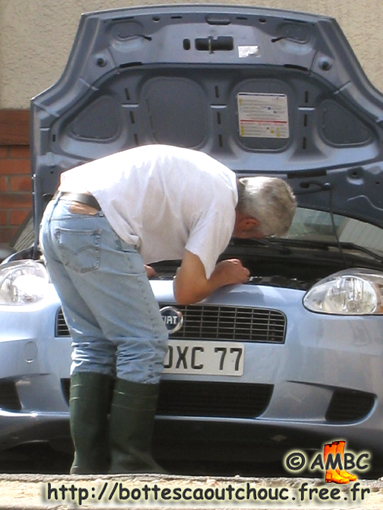 Checking his car in the hottest days of the year (Parisian area, France), 09 August 2008.