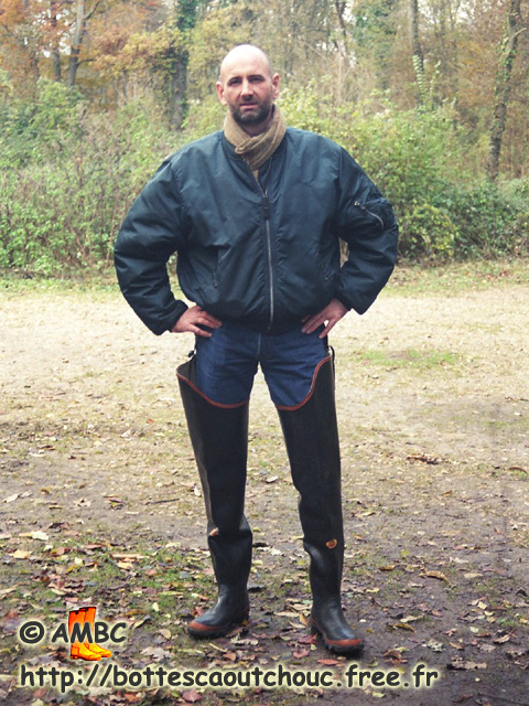 Wearing waders near a marsh.