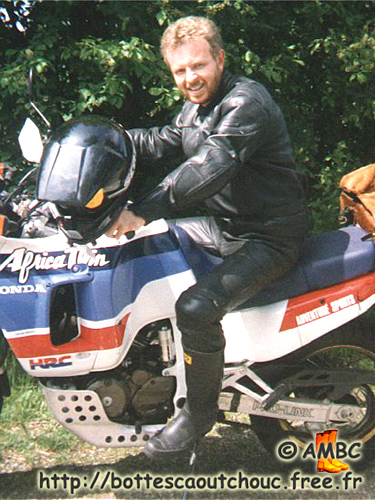 Wearing leather & rubber boots on his motorbike. 