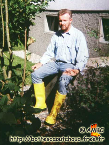 Georg wearing yellow PVC working boots at home. 