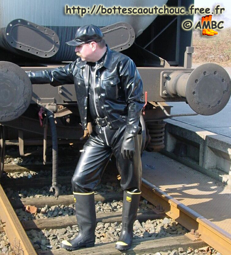Hermann wearing  rubber near a train;  2012.