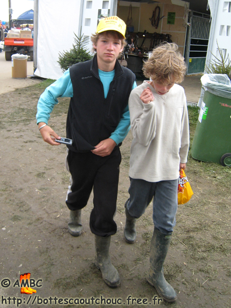 Two young rubberbooted teenagers. Libramont, Belgium. Gummistiefel, botas de goma, bottes en caoutchouc, rubber laarzen, 2007.