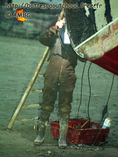 Cleaning a boat in Picardy,  France, 2003; Gummistiefel.