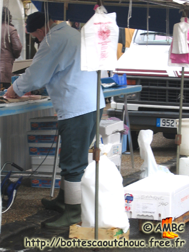 Fishmonger on a market, 2006; rubber boots, Gummistiefel.
