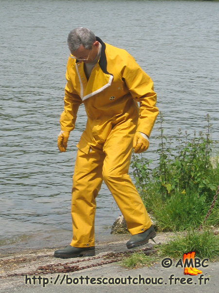 A man in PVC gear and rubber boots, at the Seine river, Dammarie Les Lys, France.
