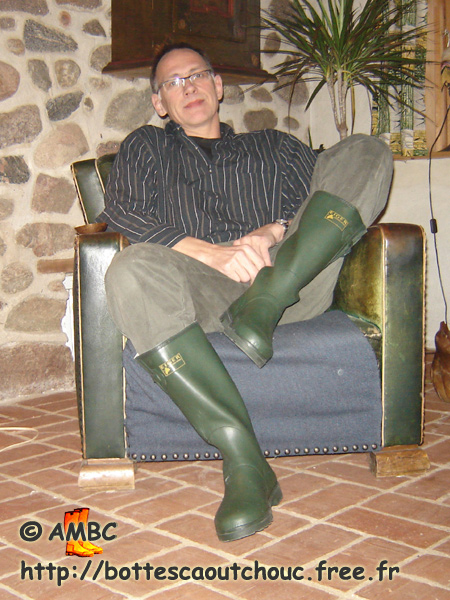 Wearing green Eiger rubber boots at home.