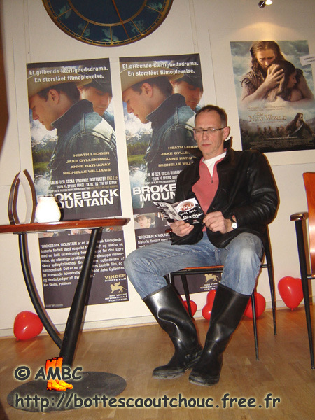 At the movies, in black gumboots.