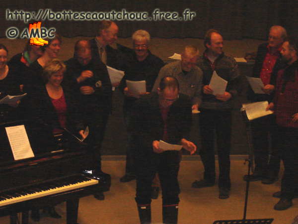 The choir master wearing gumboots.