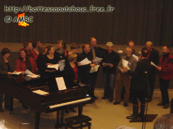 Choir leader wearing black gumboots.