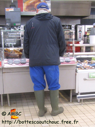 Guy wearing blue working gear and gumboots, at Carrefour supermarket, 2013. Gummistiefel, wellies, botas de goma, stivali di gomma, rubber laarzen, bottes caoutchouc.