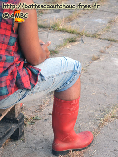 Wearing red working gumboots, Germany, 2010.