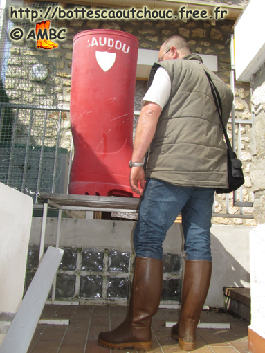 François wearing St Hubert boots in front of the red Baudou one; at the House of the Rubber Boot, France, 02 April 2011.