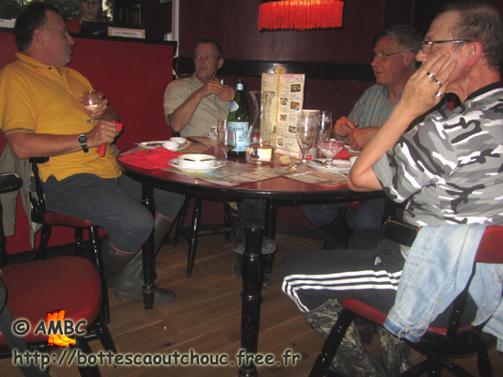Mates in wellies at the restaurant;  France,  July 2011.