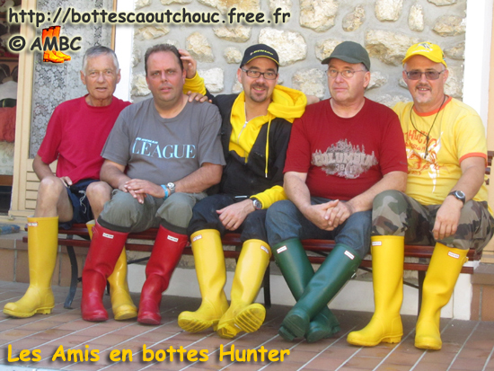 5 rubberbooted fans in coloured Hunter wellies;  France,  Sept. 2011.